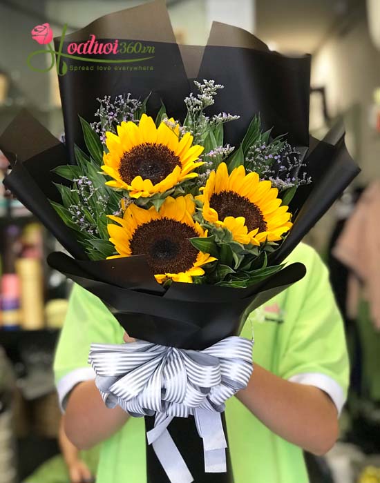 Simple long stem flowers bouquet of sunflowers is wrapped in Korean paper